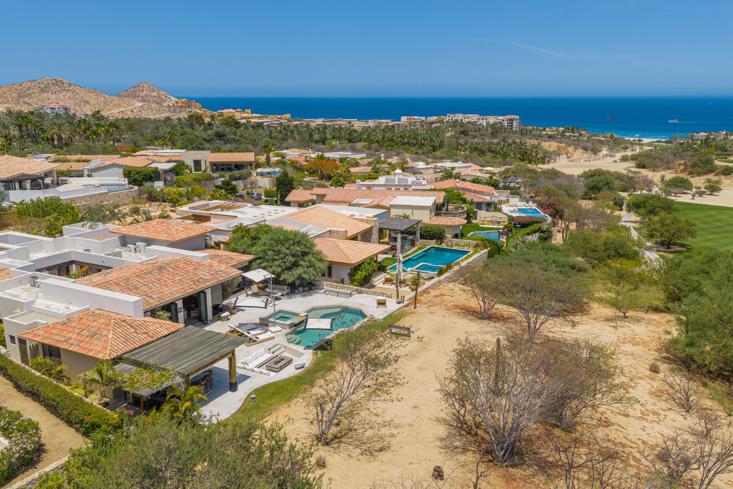 Cabo del Sol Brisas Discover Naah Payil, an exceptional estate where the warmth of a Contemporary Mexican Hacienda blends seamlessly with the relaxed sophistication of coastal living. Located within one of Los Cabos' most exclusive and secure communities, this architectural masterpiece was custom-designed by MCA, led by renowned architect Antonio Carrera. Thoughtfully enhanced in 2015 and again in 2025, the residence beautifully balances timeless character with today's highest standards of comfort and design. At the heart of the home, a central courtyard anchored by a signature tree creates a tranquil gathering space filled with natural light. The home's thoughtful design embraces effortless indoor-outdoor living. Open the grand living room doors, and refreshing ocean breezes naturally flow throughout the residence, creating a comfortable and inviting atmosphere for sale